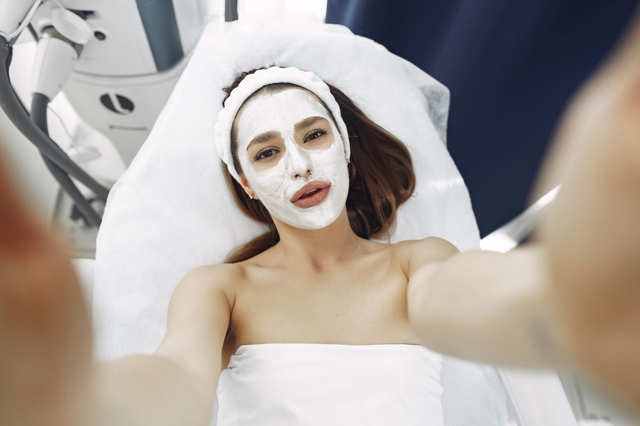 Services A woman enjoys a relaxing spa facial treatment with a moisturizing mask indoors. Perfect for wellness and skincare concepts.