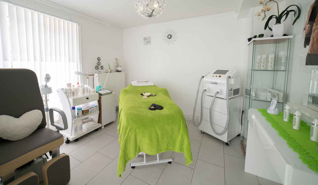 Services Bright and cozy clinic room featuring a comfortable treatment bed and modern equipment.